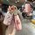 Elegant pink chevrolet key cover with louis vuitton-inspired pattern, featuring a decorative strap and back view detail for c...
