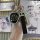 A hand holds a lada niva key fob cover, featuring a sleek black leather case with a 3-button foldable design, accompanied by ...