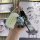 A hand holds a lexus smart key cover for rx, nx, and es models, featuring a sleek design with a cute bear charm and a stylish...