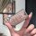A hand holds a glittery pink toyota rush/wigo key cover, showcasing its sleek design and protective features for overseas use...