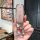 A hand holds a tengshi d9/n7/n8 key cover, showcasing its elegant pink leather design with a sparkling texture and a crystal-...