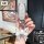 A hand holds a tengshi d9/n7/n8 key cover, showcasing its sleek silver design with a white leather bow keychain. the premium ...