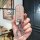 A hand holds a glittery, transparent key cover for a toyota tank or perodua raize, featuring a sleek design with a silver key...