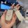 A hand holds a sparkling, glittery key cover for kia models like k3, k5, and sportage, featuring a decorative charm and a sle...