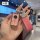 A hand holds a stylish yamaha nmax155 key cover with a pink glitter finish, adorned with a sparkling heart charm and a leathe...