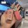 A hand holds a stylish key cover for mitsubishi outlander, featuring a pink textured design with ba yi o engraved and a heart...