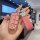 A hand holds a pink jeep key cover with a glittery finish, featuring a sleek design and a matching leather tag labeled key-ch...