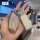 Hand holding a roewe i5 key cover with sparkling design and leather tag, showcasing premium protection and style.