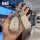 A hand holds a stylish wey blue mountain key cover for dht-phev models, featuring a sparkling silver design with a white leat...