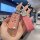 A hand holds a pink, glittery key cover for the buick verano (2021/2017 models), featuring a sleek design with a decorative c...