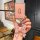 A hand holds the aito m9 key cover 2024, a premium ultra-thin card sleeve with a pink glitter finish and a decorative bow key...