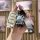 A hand holds a cheetah cs10 key cover (2014–2017) with a sleek remote protector, accompanied by a cute bear charm and a styli...