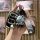 A hand holds a sleek black cheetah cs10 key cover (2014–2017) with a stylish bear-shaped keychain and a fashion strap, showca...