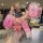 A hand holds a pink aima luna bubble key cover for e-bike remote, featuring a cute bear charm and a front view inset showcasi...