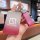 A hand holds a sleek zeekr nfc smart key cover, featuring a gradient red design with the zeekr logo and a pink leather strap ...