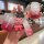 A hand holds a pink land rover key cover with a gradient design, featuring a cute bear charm and a soft tpu strap, shown in a...