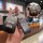 Elegant cadillac xt5 key cover featuring a sleek leather sleeve and decorative charm, showcasing the iconic logo and front vi...