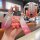 A hand holds a 2022 nissan sylphy 14th gen silicone key cover with a pink gradient design, featuring a cute bear charm and a ...