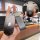 Hand holding a sleek black ideal l9 key cover with a gradient design and front view button details, featuring a decorative ch...