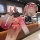 A hand holds a wuling hongguang s key cover with a gradient red design and a cute bear charm, featuring a front view of the k...
