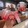 Hand holding a baojun 730 key cover with gradient red design, featuring a cute bear charm and front view of the smart key pro...