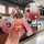 A hand holds a pink peugeot tpu key cover with a cute bear charm, showcasing its front view and sleek design for 308, 2008, 3...
