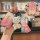 A hand holds a stylish pink cadillac key cover for models like xt5 and ct6, featuring a cute bear charm and a fashion strap, ...