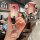 A hand holds a gradient pink buick key cover for excelle, regal, gl8 & enclave, featuring a cat-shaped keychain and a front v...
