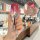 A hand holds a 2024 toyota sienna key cover, showcasing its sleek red gradient design and front view with functional buttons,...