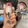 Hand holding a kia key cover with gradient pink and silver design, featuring a cat-shaped keychain and front view inset showc...