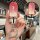 A hand holds a jeep key cover with a gradient pink design, featuring a cat-shaped keychain. the front view highlights the jee...