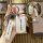A hand holds a white wuling key cover with a sleek front design, featuring the wuling logo and a matching wrist strap, showca...
