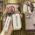 Hand holding a wuling xingchen key cover with premium leather strap and sleek front design, showcasing elegant protection for...