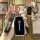 A hand holds a sleek black dongfeng venucia key cover for the d60 plus & xing 2023, featuring a polished front design with th...