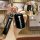 Hand holding a sleek black baojun 510 key cover with rs3 snap, showcasing the front design and leather strap for premium prot...