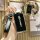 A hand holds a sleek black chery key cover with a leather strap, showcasing its front design featuring the chery logo and mod...