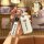 A hand holds a roewe key cover with a sleek white design and roewe branding, featuring a matching leather strap. the front de...