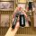 A hand holds a sleek black mazda key cover with the brand logo, designed for models like mazda 6, 3, mx-5, and cx-7, showcasi...