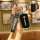 A hand holds a sleek black roewe key cover sleeve, showcasing its front design with the roewe logo and a matching leather str...
