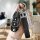 A hand holds a sleek black changan suzuki vitara key cover with a diamond-encrusted h charm and numbered tag, set against a m...