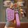 A hand holds a pink jac key cover for sehao e50a, jiayue a5x, ruifeng s4/s7/m6, featuring a sleek design with a leather strap...