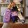 A hand holds a purple geely key cover for models like emgrand gs and vision x6, featuring a bear-shaped charm and a stylish s...