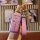 A hand holds a pink aion y key cover with a diamond-patterned strap and a numbered charm, showcasing its stylish design for g...