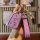 A hand holds a cadillac xt5 key cover, featuring a pink leather sleeve with a quilted design and a matching keychain adorned ...
