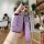 Elegant purple leather key cover for vw passat 2022, featuring a sleek remote protector with a quilted strap and crystal-embe...