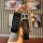 A hand holds a sleek black gac trumpchi gs4 key cover with a leather strap and a decorative h charm, showcasing its elegant d...