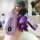 A hand holds a purple mercedes c260l key cover with a glittery bear charm and a matching wrist strap, showcasing its sleek de...