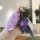 A hand holds a purple b70 key cover for the 2022 faw besturn, featuring a sleek design with three buttons and a matching bear...