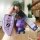 A hand holds a purple bmw key cover for 3/5/7 series, x1, x3, and x5 models, featuring a sleek leather design with a matching...