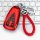 Red leather key cover for changan cs75 plus, featuring a braided red strap and silver clasp, displayed on a keyboard backgrou...